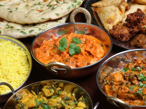 Butter chicken and curries served in copper karahi bowls